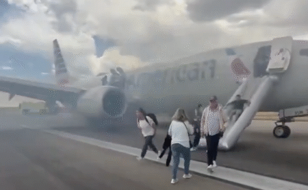 people walking on a runway with a plane in the background